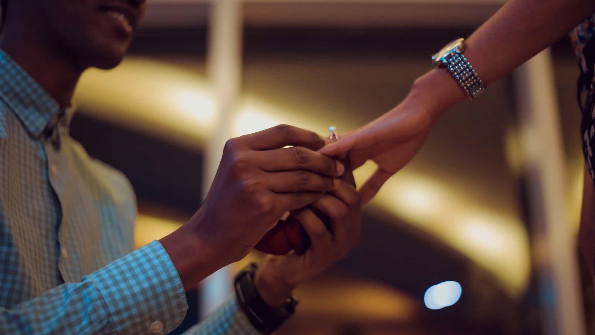 A Man Putting an Engagement Ring on a Woman's Finger Close Up